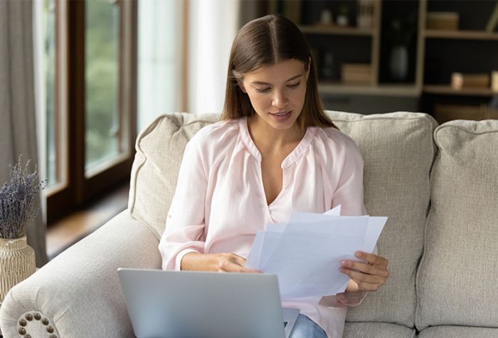 Woman Looking Over Documents